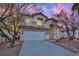 Two-story house with a landscaped front yard, driveway, and attached garage at 295 Blackstone River Ave, Las Vegas, NV 89148