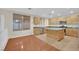 Kitchen with island, wood cabinets, and stainless steel appliances at 295 Blackstone River Ave, Las Vegas, NV 89148