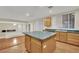 Kitchen island, light wood cabinets, and a view into the living area at 295 Blackstone River Ave, Las Vegas, NV 89148