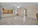 Open living room with kitchen and staircase views, tile floors at 295 Blackstone River Ave, Las Vegas, NV 89148