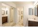 Large bathroom with dual vanities, tiled floors, and mirrored closet at 3017 Saint George St # B, North Las Vegas, NV 89030