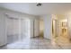 Bright bedroom with tile floors, sliding door to patio, and mirrored closet at 3017 Saint George St # B, North Las Vegas, NV 89030