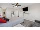 Bedroom with a ceiling fan, large TV, and gray bedding at 4027 Boratko St, Las Vegas, NV 89115