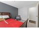 Relaxing bedroom with a red bed and a gray armchair at 4027 Boratko St, Las Vegas, NV 89115