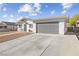 Ranch style home with gray garage door and landscaped yard at 4027 Boratko St, Las Vegas, NV 89115