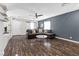 Living room with hardwood floors, sectional sofa, and ceiling fan at 4027 Boratko St, Las Vegas, NV 89115