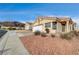 Single-story house with a tan stucco exterior, red tile roof, and a two-car garage at 408 Matecumbe Way, Boulder City, NV 89005