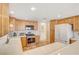 Bright kitchen with light wood cabinets, stainless steel appliances, and tile flooring at 408 Matecumbe Way, Boulder City, NV 89005