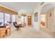 Open living room with a view into a hallway, featuring neutral tones and wood accents at 408 Matecumbe Way, Boulder City, NV 89005