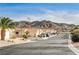 Street view of charming homes with mountain backdrop at 408 Matecumbe Way, Boulder City, NV 89005