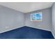 Blue carpeted bedroom with a window and neutral walls at 4730 E Craig Rd # 2158, Las Vegas, NV 89115