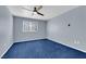 Blue carpeted bedroom with a ceiling fan and window at 4730 E Craig Rd # 2158, Las Vegas, NV 89115