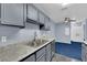 Gray kitchen with stainless steel appliances and granite countertops at 4730 E Craig Rd # 2158, Las Vegas, NV 89115