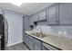 Gray kitchen cabinets and granite countertops at 4730 E Craig Rd # 2158, Las Vegas, NV 89115