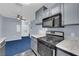 Modern kitchen featuring stainless steel stove and microwave at 4730 E Craig Rd # 2158, Las Vegas, NV 89115