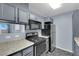 Kitchen features gray cabinets and stainless steel appliances at 4730 E Craig Rd # 2158, Las Vegas, NV 89115