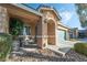 Inviting front porch with seating area, two-car garage, and landscaped yard at 5370 Cholla Cactus Ave, Las Vegas, NV 89141