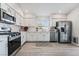 Modern kitchen with white cabinets, stainless steel appliances, and gray flooring at 5370 Cholla Cactus Ave, Las Vegas, NV 89141