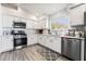 Modern kitchen with white cabinets, stainless steel appliances and gray flooring at 5370 Cholla Cactus Ave, Las Vegas, NV 89141