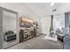 Open living area with gray sectional sofa, large mirror, and view into kitchen at 5370 Cholla Cactus Ave, Las Vegas, NV 89141