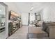 Living room features gray sectional sofa, large TV, and stylish decor at 5370 Cholla Cactus Ave, Las Vegas, NV 89141