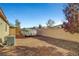 Backyard with gravel, block wall, and covered boat trailer at 5805 Vibrant Violet Ct, Las Vegas, NV 89130