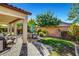 Covered patio, grassy area, firepit, and dining furniture at 5805 Vibrant Violet Ct, Las Vegas, NV 89130