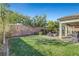 Large backyard with grassy area and covered patio at 5805 Vibrant Violet Ct, Las Vegas, NV 89130