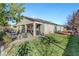 Covered patio, grassy area, firepit, and dining furniture at 5805 Vibrant Violet Ct, Las Vegas, NV 89130