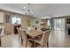 Bright dining room features a rustic wooden table and six chairs at 5805 Vibrant Violet Ct, Las Vegas, NV 89130