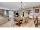 Open concept dining area with rustic table and view of living room at 5805 Vibrant Violet Ct, Las Vegas, NV 89130