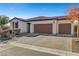 Single-story house with three-car garage and brick driveway at 5805 Vibrant Violet Ct, Las Vegas, NV 89130