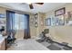 Home office features a wall of art, window, and room for fitness equipment at 5805 Vibrant Violet Ct, Las Vegas, NV 89130