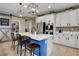 Modern kitchen with white cabinets and a blue island at 5805 Vibrant Violet Ct, Las Vegas, NV 89130