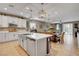 Open concept kitchen with white cabinets and island at 5805 Vibrant Violet Ct, Las Vegas, NV 89130