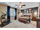 Large bedroom with king-size bed, accent wall, and exercise bike at 5805 Vibrant Violet Ct, Las Vegas, NV 89130