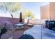 Backyard with patio, table, chairs, and grill at 6074 Lazarro Ct, Las Vegas, NV 89139