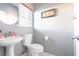 Small bathroom with pedestal sink, toilet, and gray walls at 6074 Lazarro Ct, Las Vegas, NV 89139