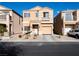 Two-story house with tan exterior and two-car garage at 6074 Lazarro Ct, Las Vegas, NV 89139