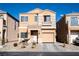 Two-story house with beige exterior, attached garage, and landscaping at 6074 Lazarro Ct, Las Vegas, NV 89139