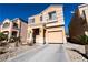 Two-story house with beige exterior, attached garage, and landscaping at 6074 Lazarro Ct, Las Vegas, NV 89139