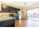 Modern kitchen features dark cabinetry, stainless steel appliances, and wood flooring at 6074 Lazarro Ct, Las Vegas, NV 89139