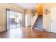 Living room with hardwood floors, sliding glass doors to patio, and staircase at 6074 Lazarro Ct, Las Vegas, NV 89139