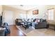 Living room with sectional sofa, coffee table, and hardwood floors at 6074 Lazarro Ct, Las Vegas, NV 89139