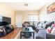 Living room featuring sectional sofa, coffee table, and hardwood floors at 6074 Lazarro Ct, Las Vegas, NV 89139