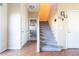 Gray carpeted staircase with hardwood flooring on the landing at 6074 Lazarro Ct, Las Vegas, NV 89139