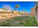 Spacious backyard with grassy area and mature trees at 6228 Wood Stork Ave, Las Vegas, NV 89122