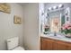 Small bathroom with wood vanity and a pedestal sink at 6228 Wood Stork Ave, Las Vegas, NV 89122