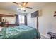 Bedroom with ceiling fan, queen bed, and mirrored dresser at 6228 Wood Stork Ave, Las Vegas, NV 89122