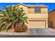 Two-story house with beige exterior, palm tree, and attached garage at 6228 Wood Stork Ave, Las Vegas, NV 89122